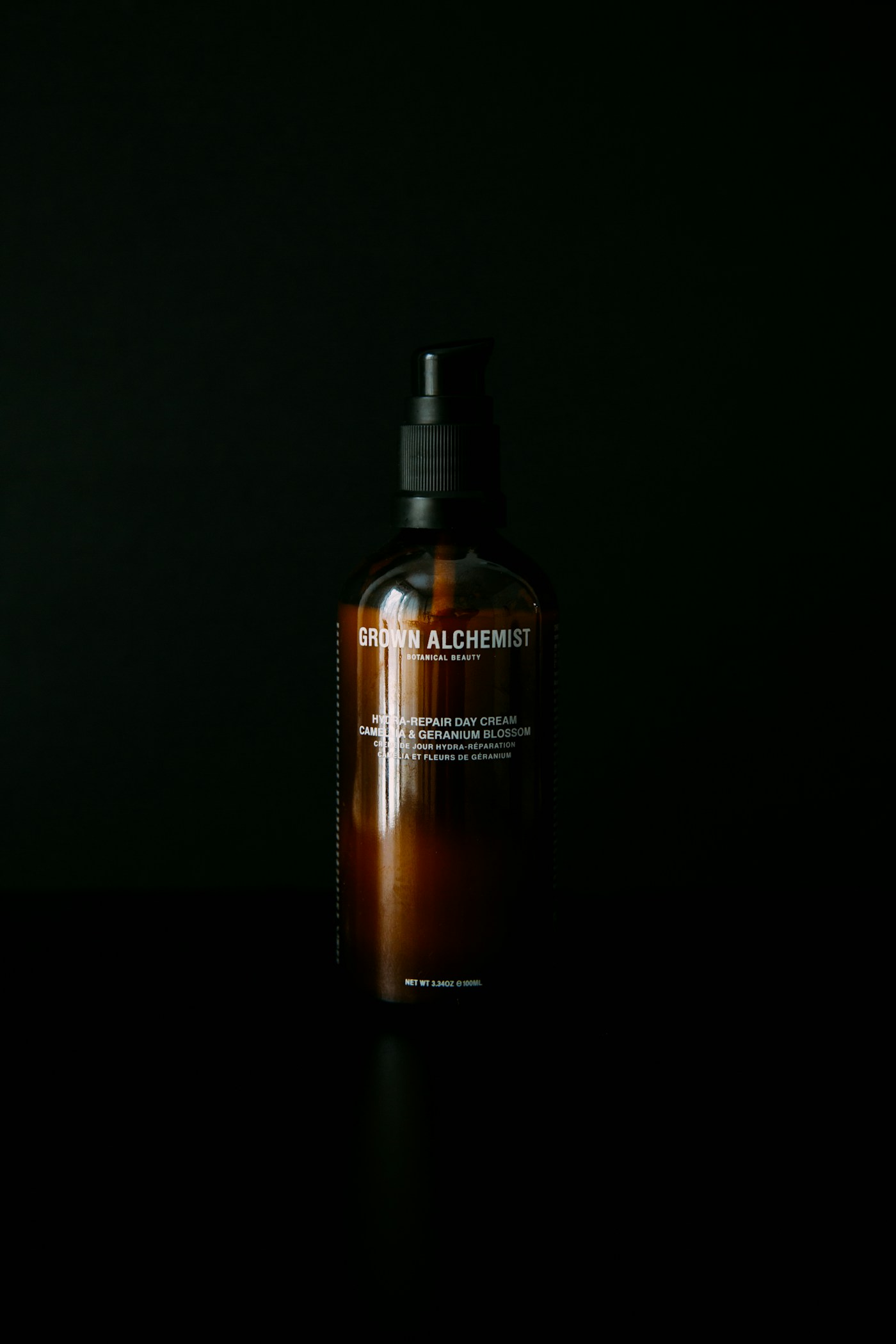 Amber skincare bottle against a dark background